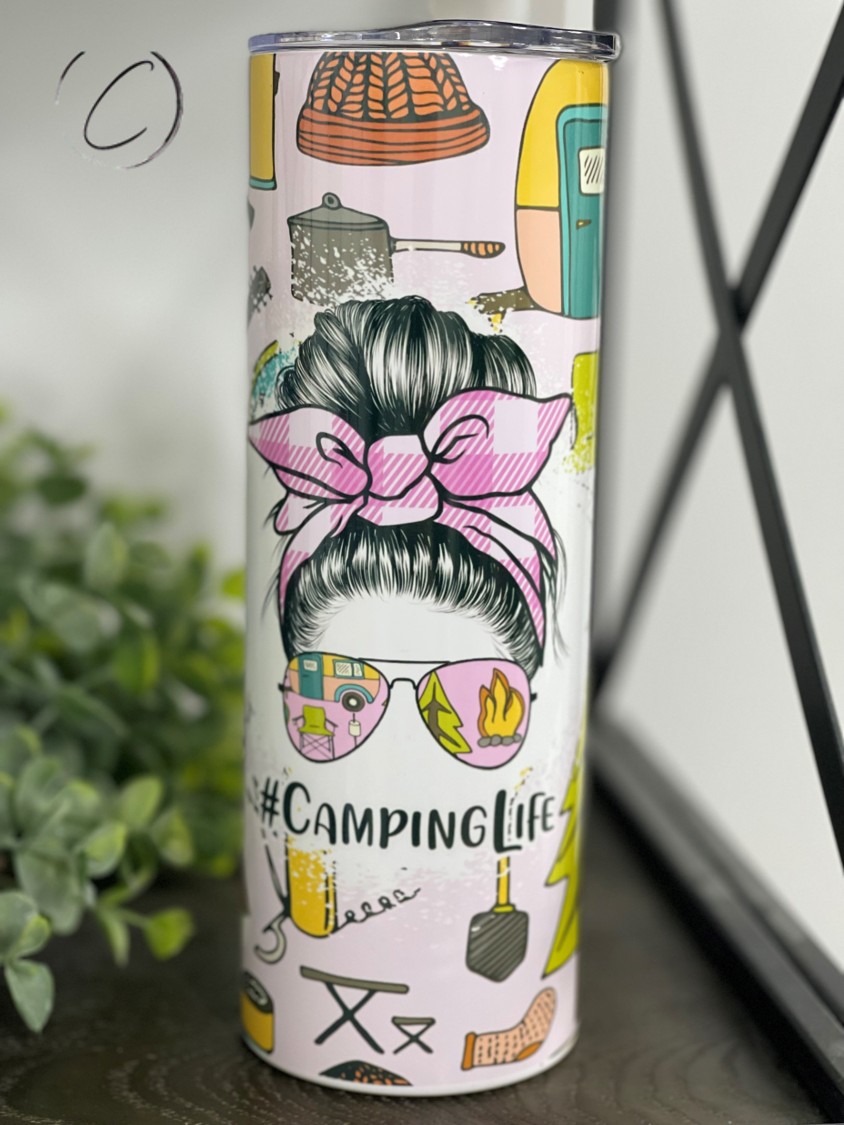 A stylish #CampingLife 20oz skinny tumbler with a vibrant outdoor-themed design, featuring a reusable straw.