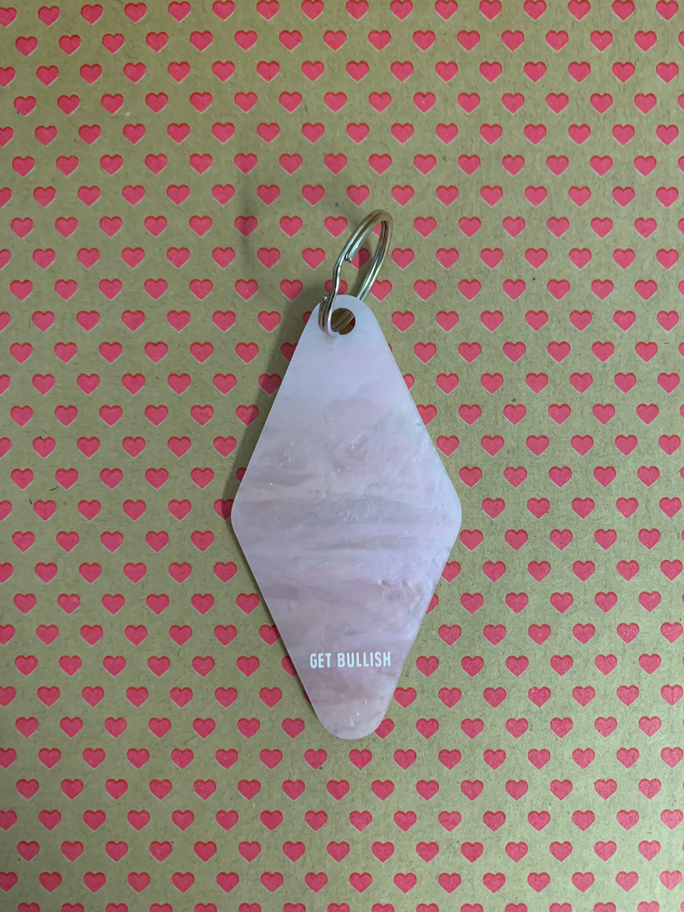 Chateau Des Heaux Motel Style Keychain in Crystal Pink with white lettering, featuring a split ring for key attachment.