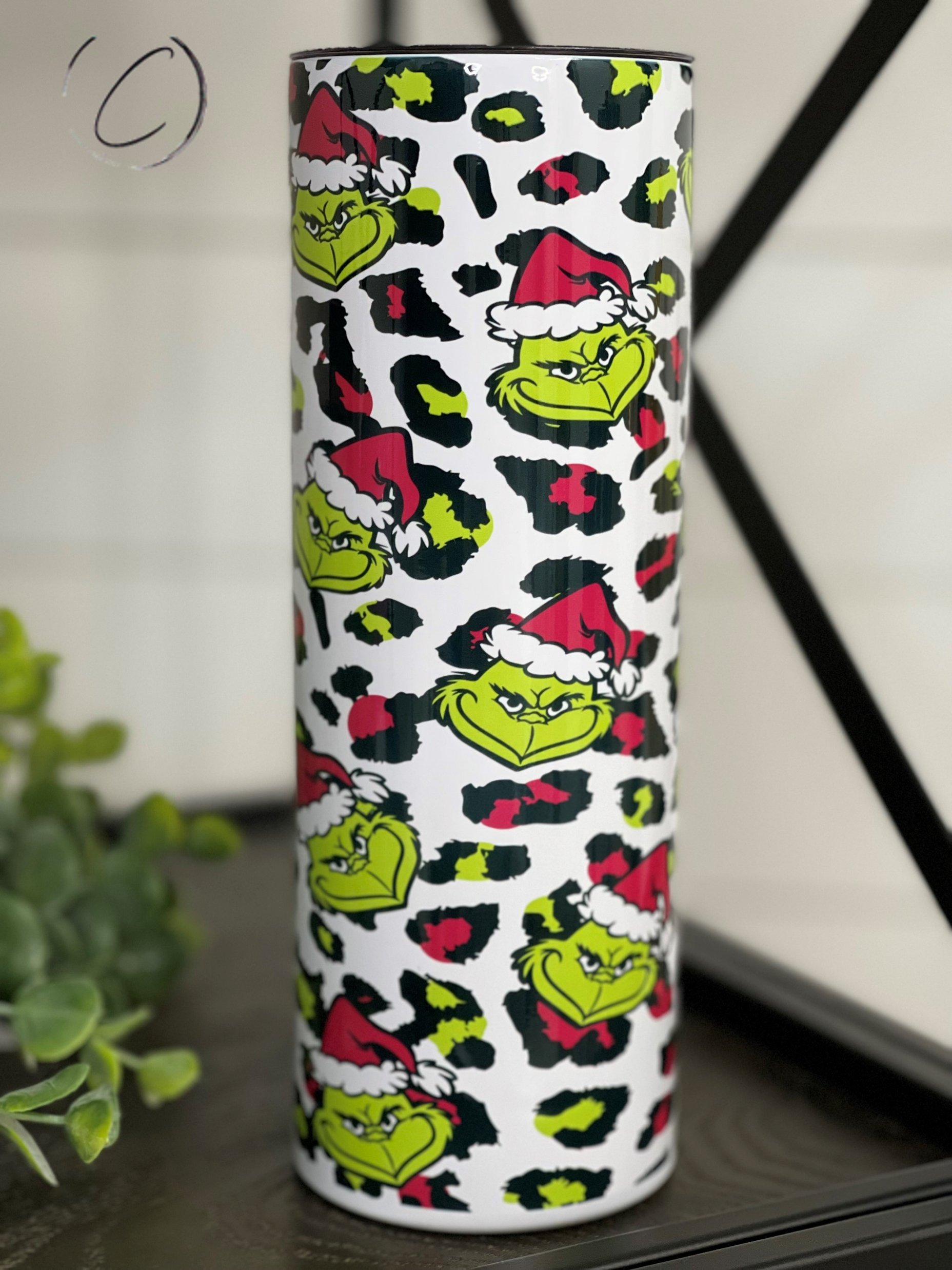 Cheetah Grinch 20oz Skinny Tumbler with vibrant design and reusable straw.