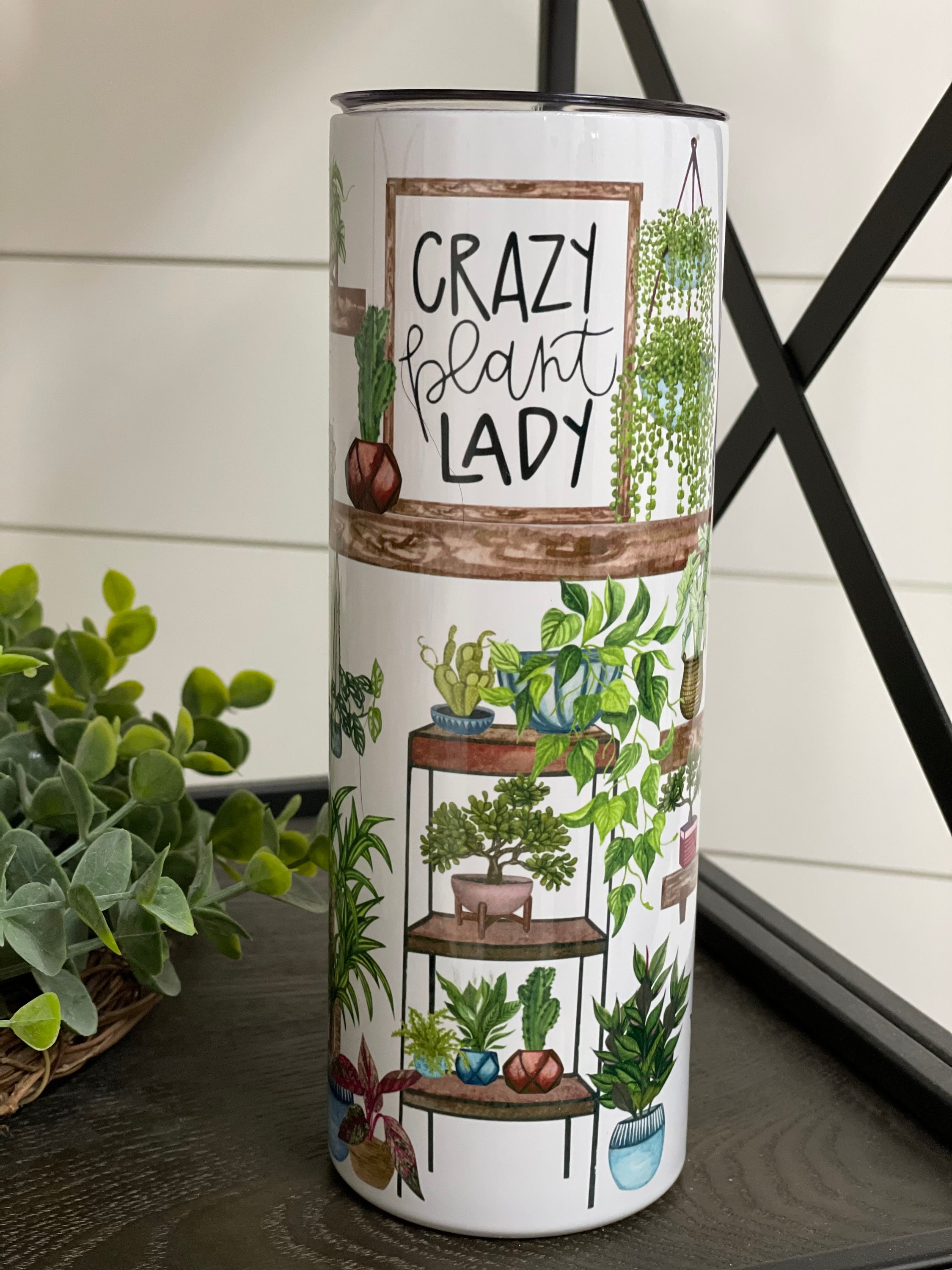 A stylish 20oz skinny tumbler featuring a vibrant plant-themed design, perfect for plant lovers, with a reusable straw included.