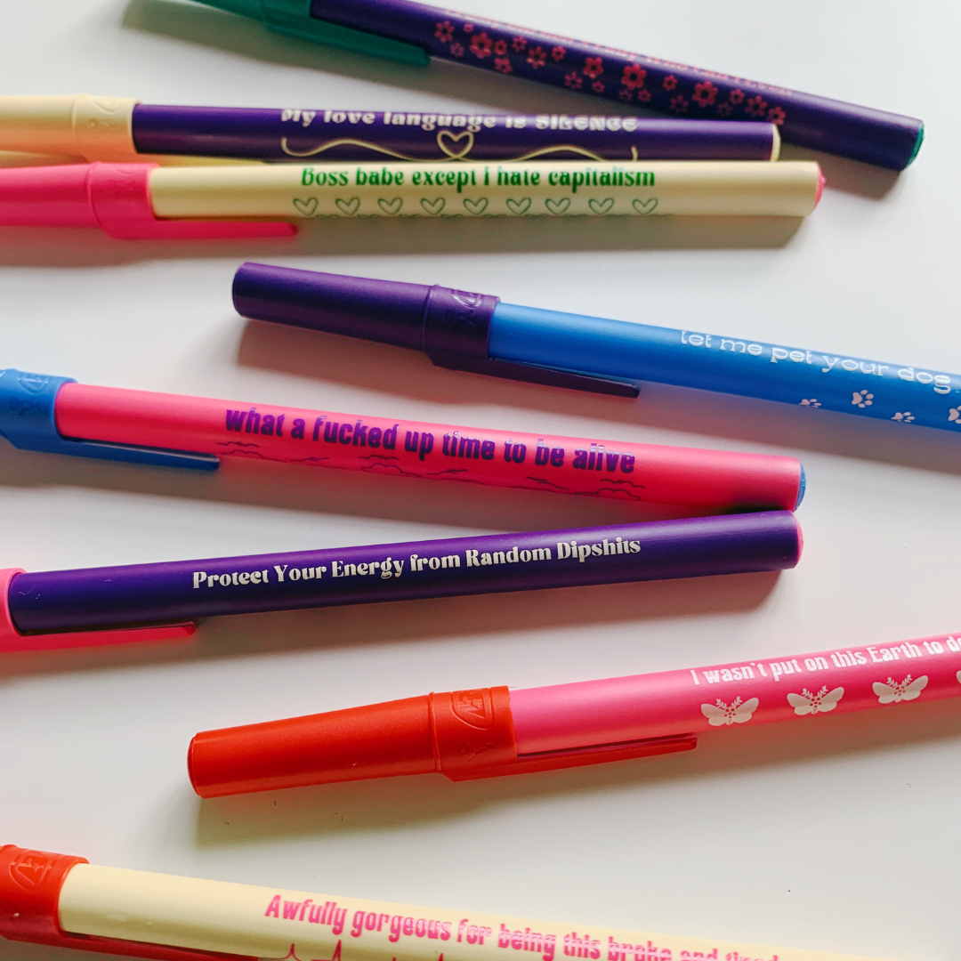 A stylish violet ballpoint pen with a fine point and blue ink, embodying a modern Gen Z aesthetic.