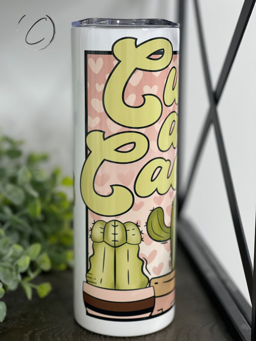 Cuddly As A Cactus 20oz Skinny Tumbler featuring a vibrant cactus design, reusable straw, and insulated body.