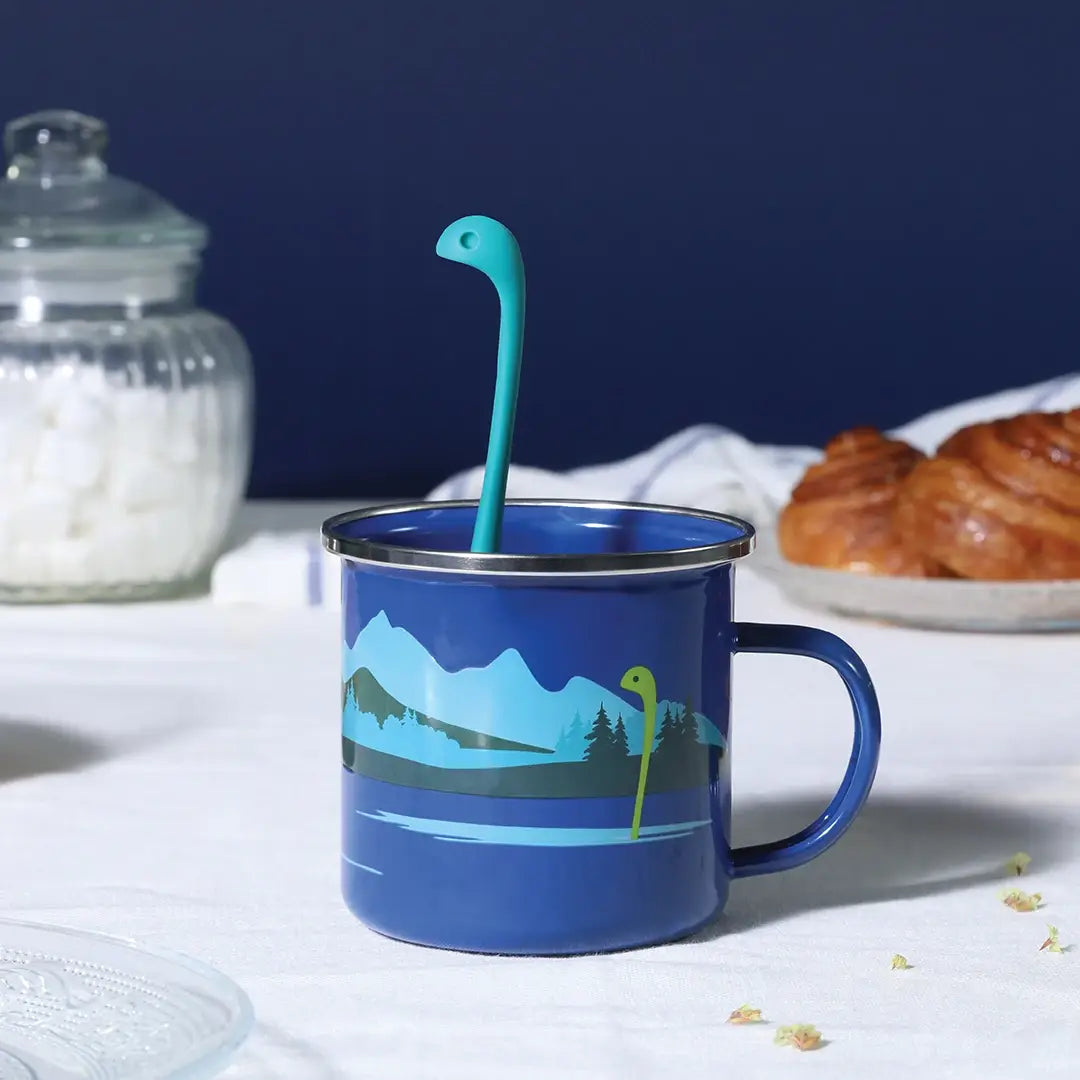 Cup of Nessie Blue Dinosaur Tea Infuser and Cup featuring a playful dinosaur design, made from BPA-free materials, perfect for brewing tea.