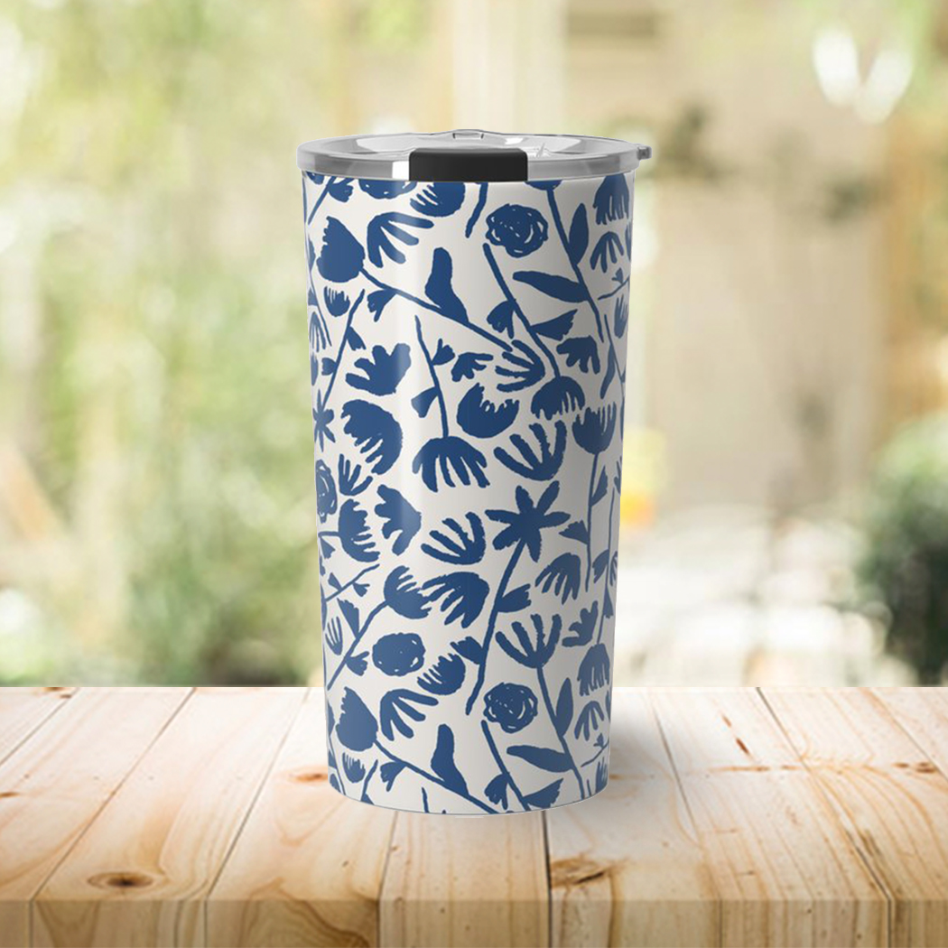 Dark blue travel coffee mug with floral design, featuring a stainless steel body and a vacuum-sealed lid.