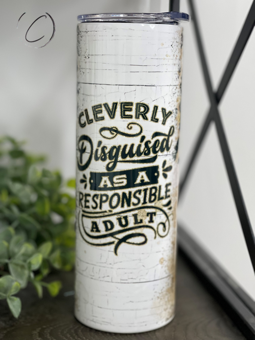 Disguised As An Adult 20oz Skinny Tumbler with a full wrap design, featuring a reusable straw and vibrant colors.