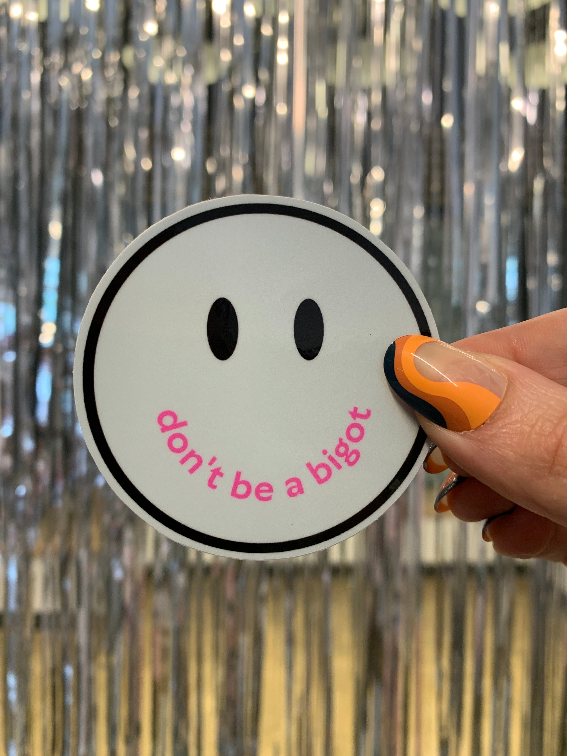 Don't Be a Bigot Smile Face Sticker with vibrant colors and a positive message promoting inclusivity.