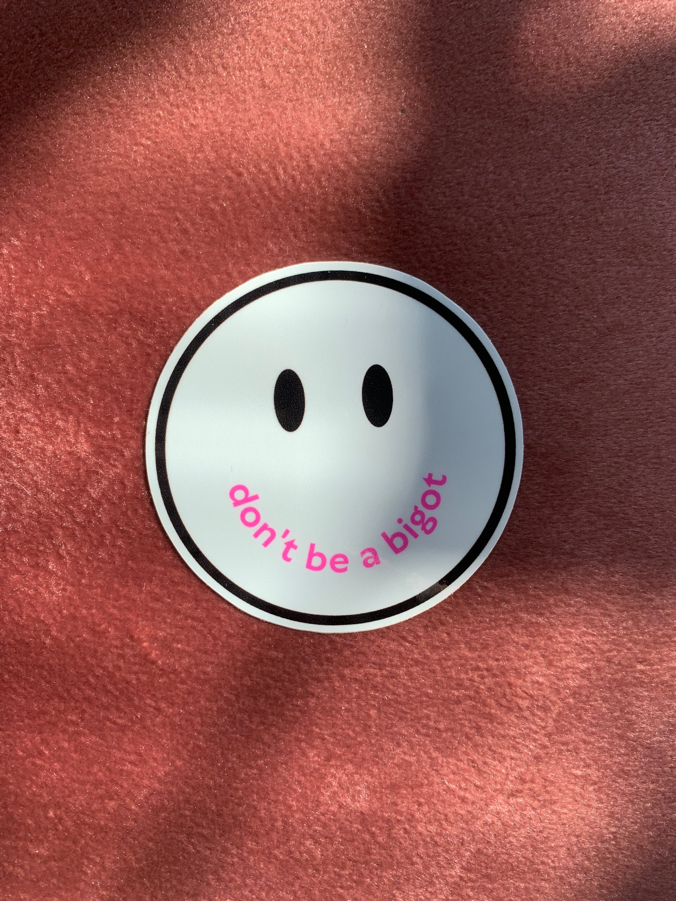 Don't Be a Bigot Smile Face Sticker with vibrant colors and a positive message promoting inclusivity.