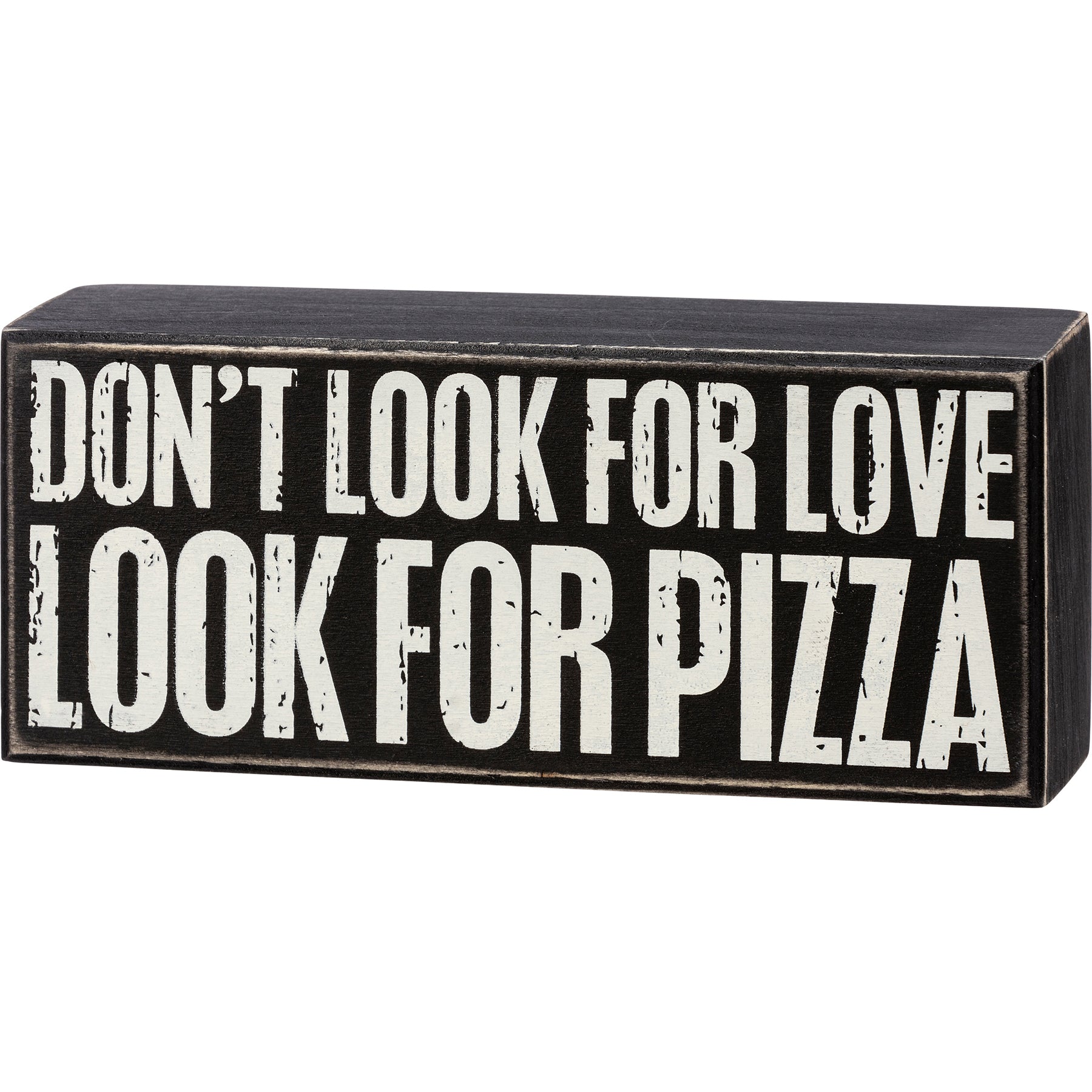 A rustic wooden box sign with a distressed black and white design featuring the phrase 'Don't Look For Love Look For Pizza'.