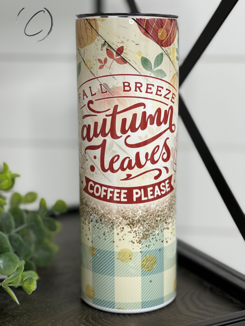 A 20oz skinny tumbler featuring a vibrant autumn leaves design, perfect for coffee and other beverages.