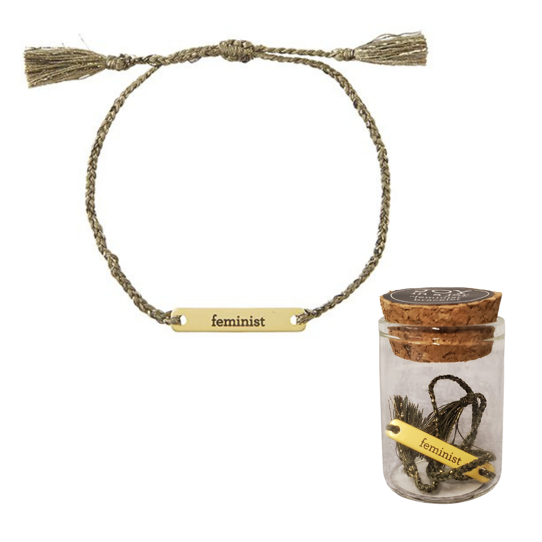 Feminist Stamped Brass Bar Woven Thread Bracelet displayed in a giftable glass jar with cork lid.