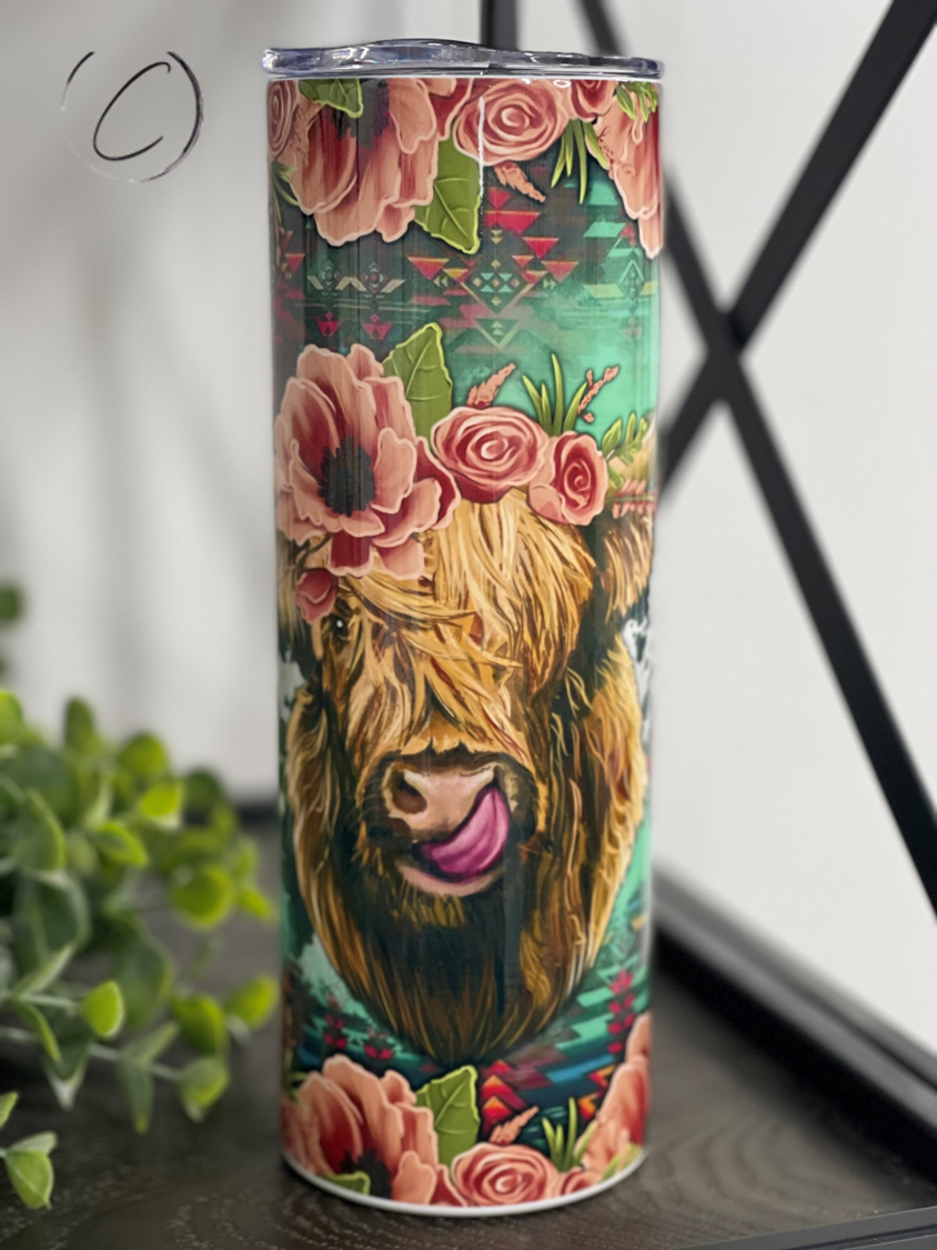 A stylish Floral Highland Cow 20oz Skinny Tumbler featuring a vibrant floral design, perfect for hot and cold beverages.
