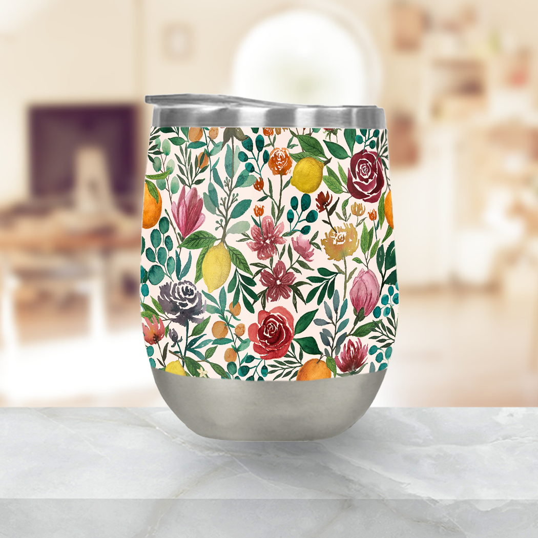 Fruit and Flowers Stemless Wine Tumbler with vibrant floral design, showcasing its stainless steel construction and included plastic lid.
