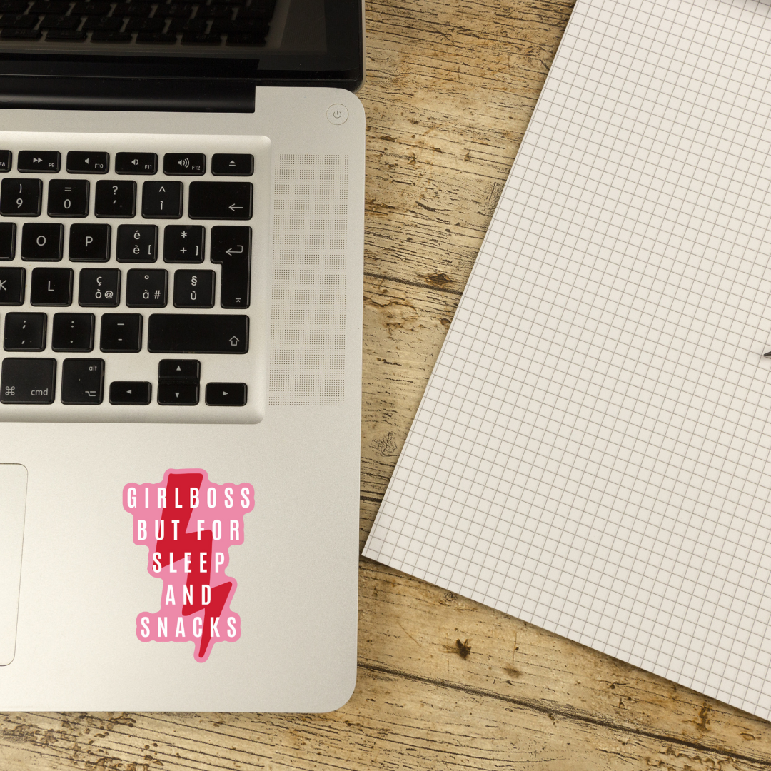 Glossy die cut vinyl sticker featuring the phrase 'Girl Boss But For Sleep and Snacks' in vibrant colors, perfect for personalizing items.