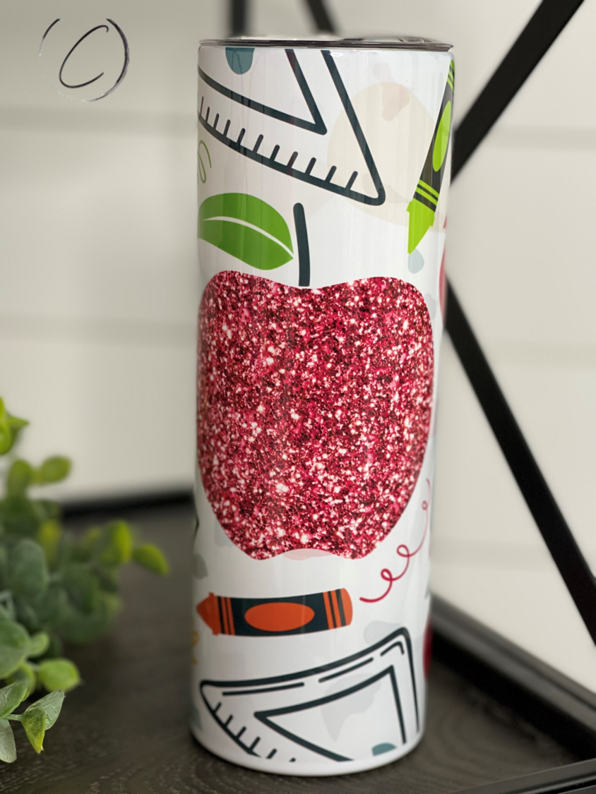 Glitter Apple 20oz Skinny Tumbler with a vibrant glitter apple design, featuring a reusable straw and a sleek insulated body.
