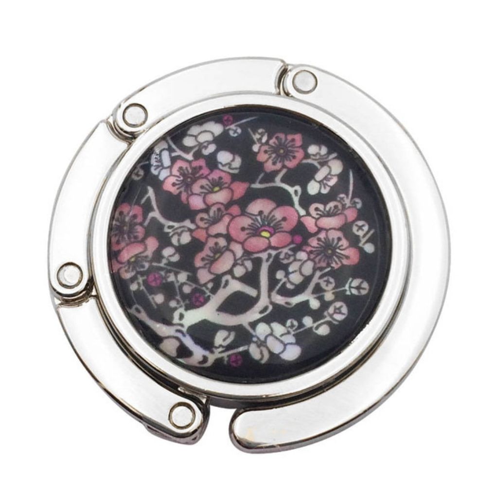 Stylish silver graphic purse hanger with a decorative medallion, designed to keep handbags off the floor.