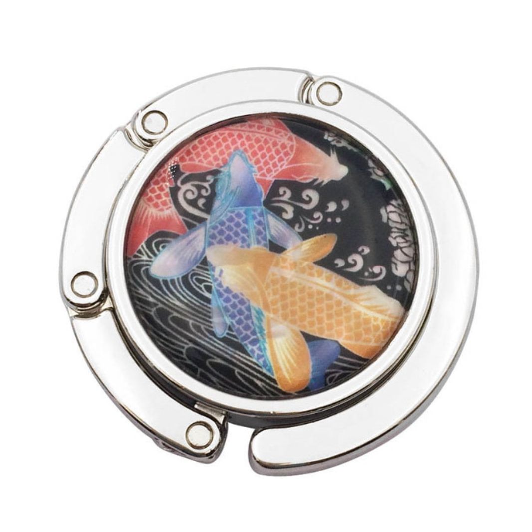 Stylish silver graphic purse hanger with a decorative medallion, designed to keep handbags off the floor.