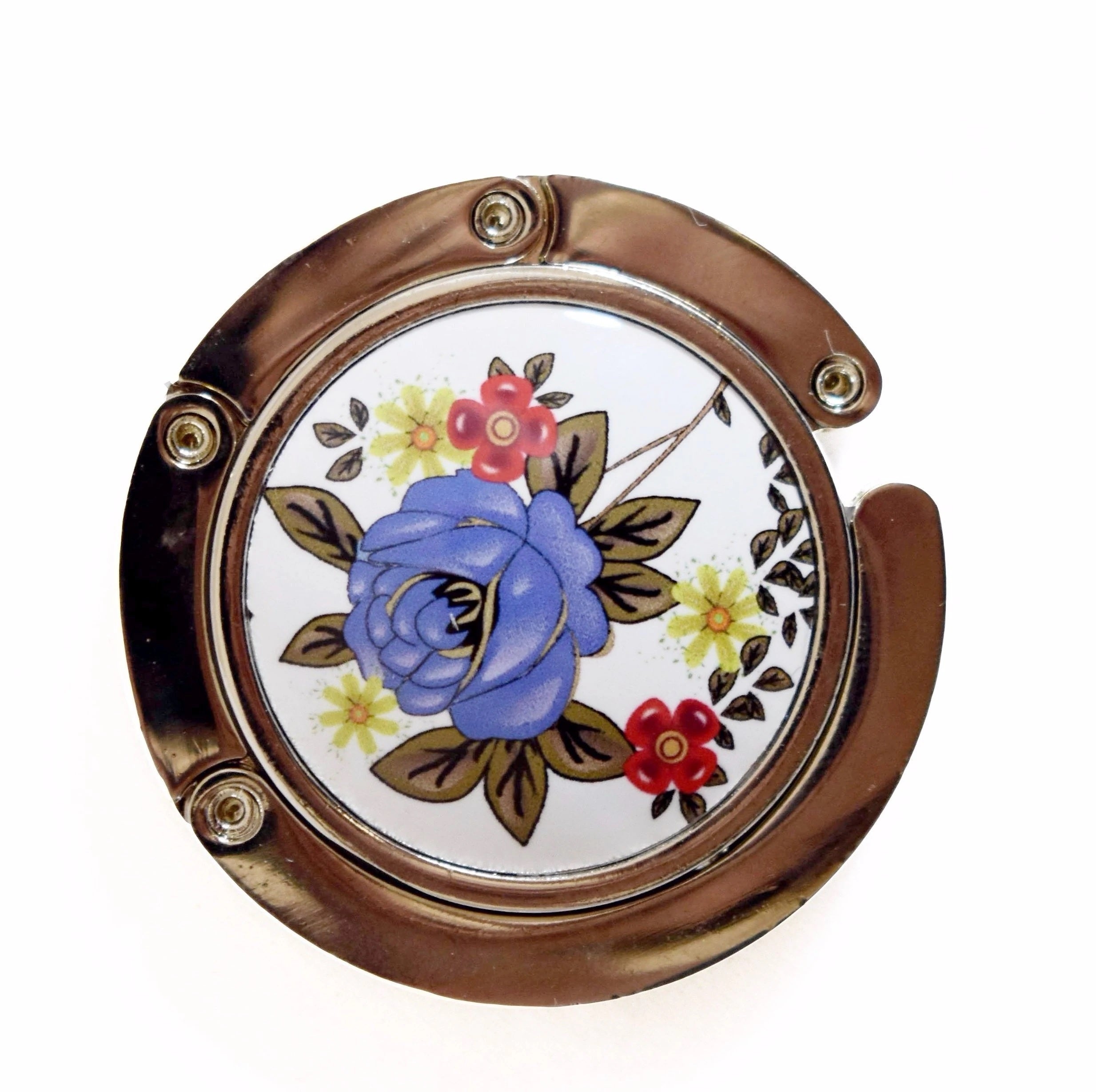 Stylish silver graphic purse hanger with a decorative medallion, designed to keep handbags off the floor.