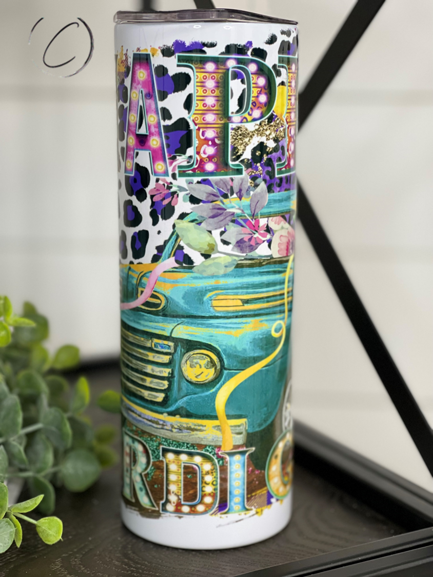 Happy Mardi Gras Truck 20oz Skinny Tumbler featuring vibrant colors and a festive design, perfect for drinks on the go.