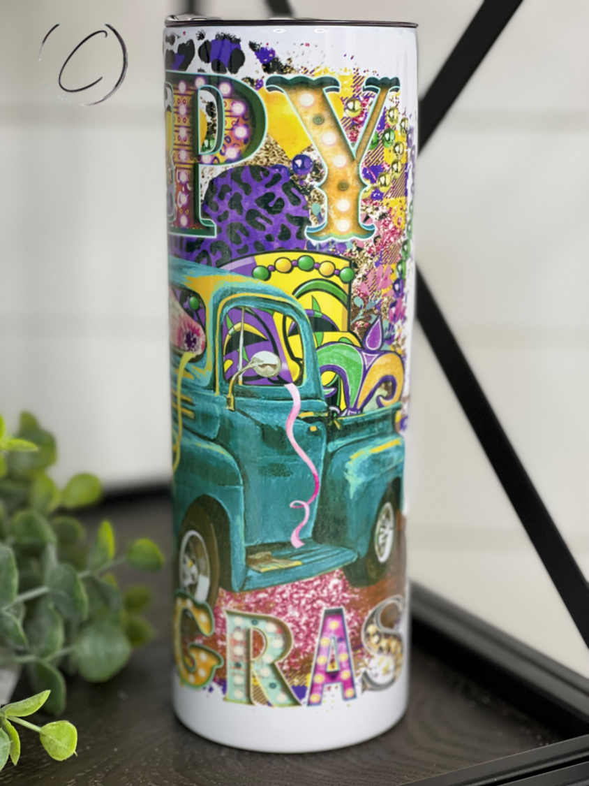 Happy Mardi Gras Truck 20oz Skinny Tumbler featuring vibrant colors and a festive design, perfect for drinks on the go.