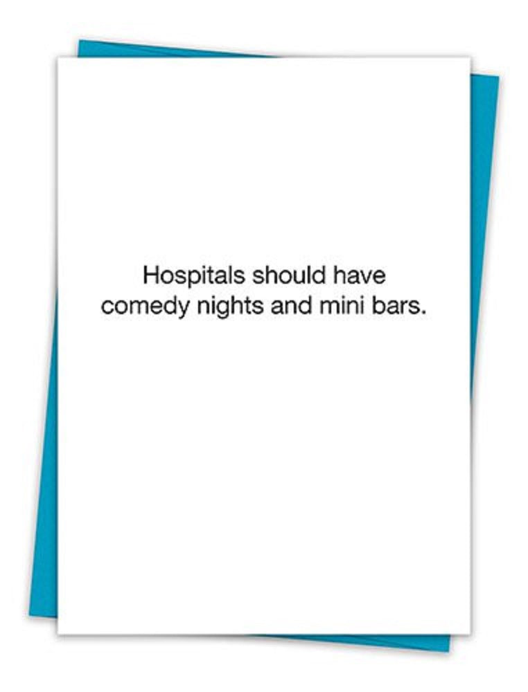 A humorous greeting card featuring the text 'Hospitals should have comedy nights and mini bars' on a minimalist white background, accompanied by a teal envelope.