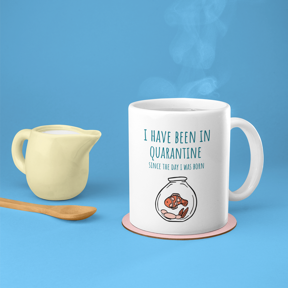 A white ceramic mug with the phrase 'I Have Been in Quarantine Since The Day I Was Born' printed on it, featuring a classic shape and C-handle.