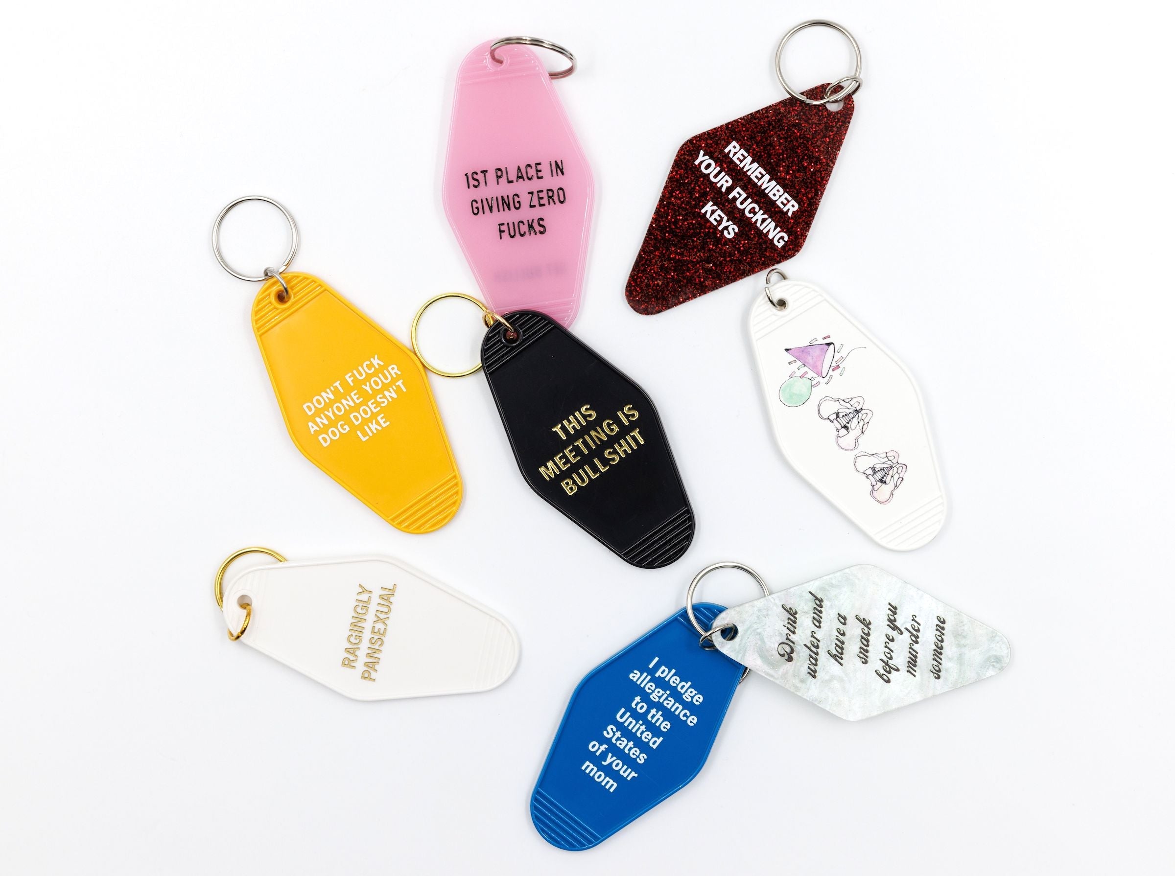 Blue motel keychain with the phrase 'I Pledge Allegiance to the United States of Your Mom' and a split ring attachment.