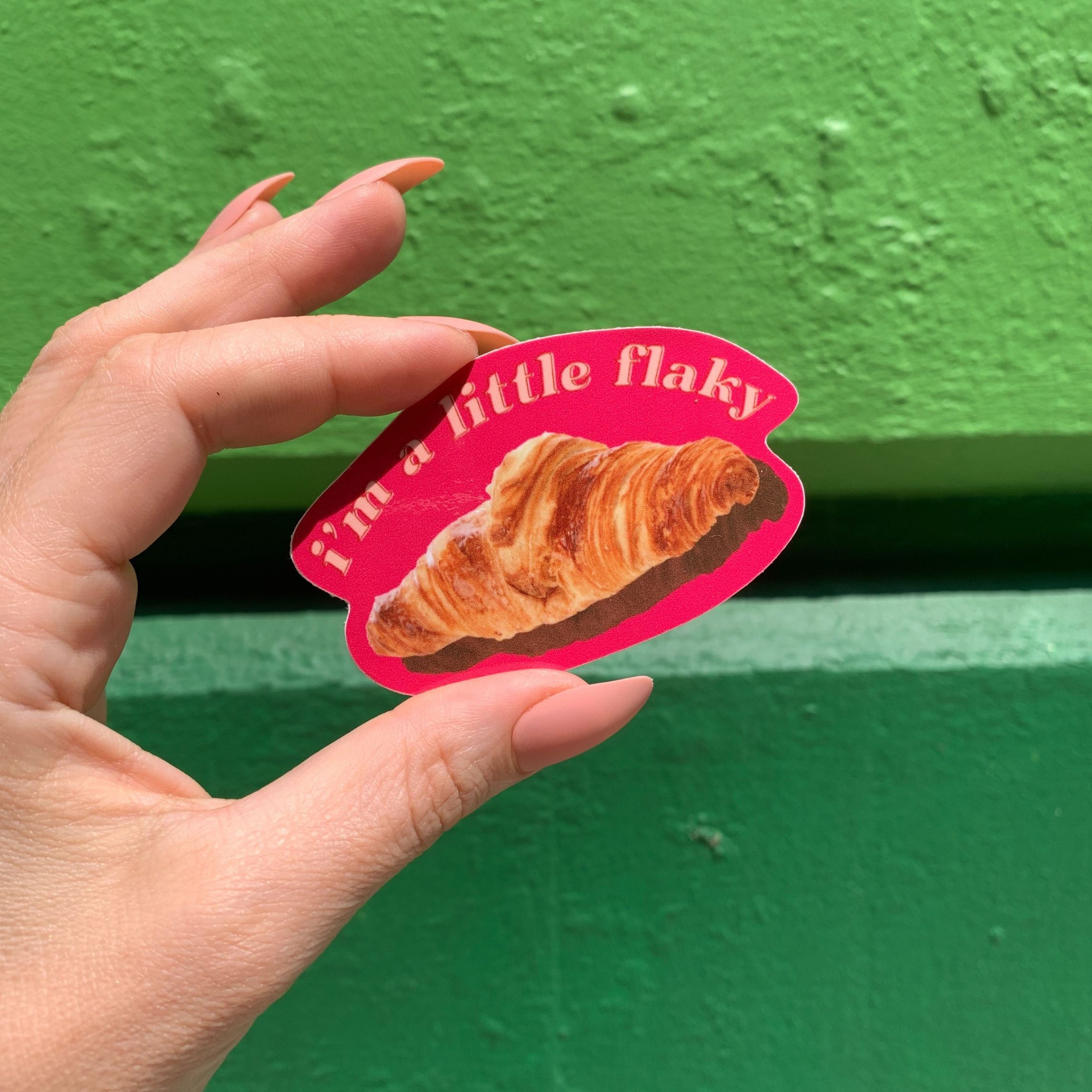 A vinyl die cut decal featuring a croissant with the text 'I’m a Little Flaky', perfect for personalizing items.