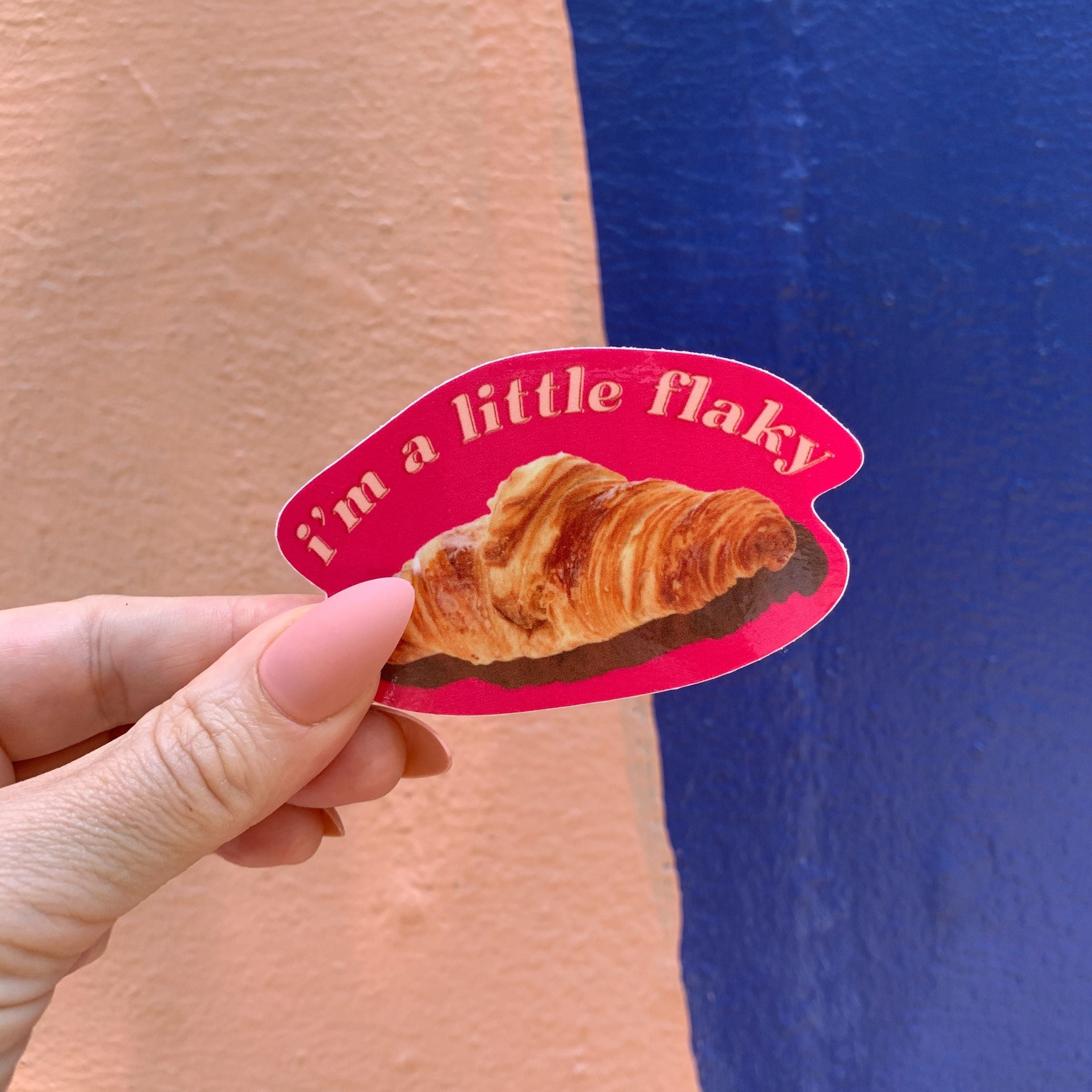 A vinyl die cut decal featuring a croissant with the text 'I’m a Little Flaky', perfect for personalizing items.