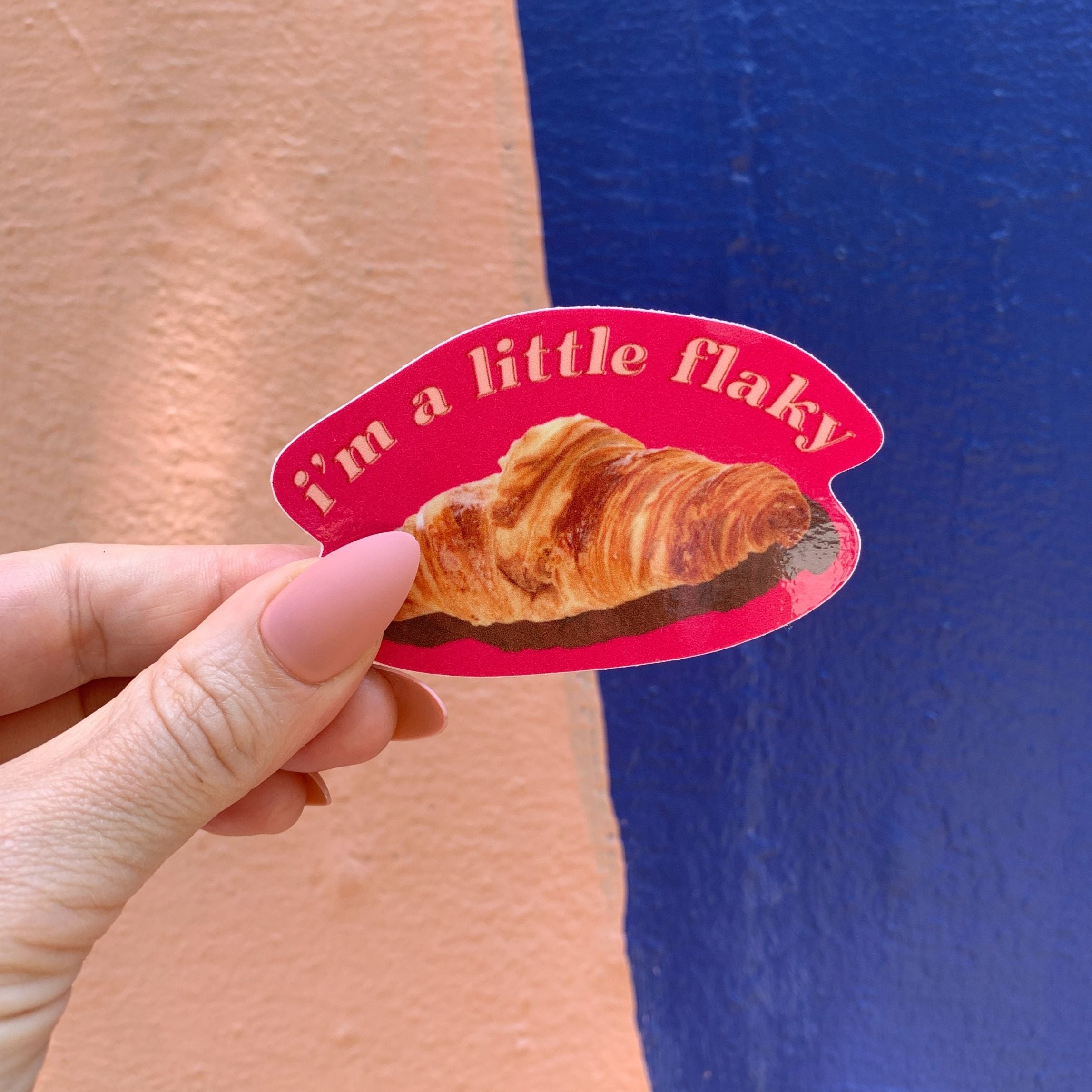 A vinyl die cut decal featuring a croissant with the text 'I’m a Little Flaky', perfect for personalizing items.