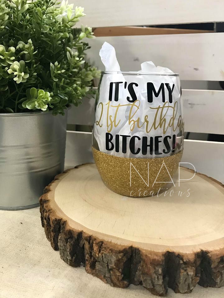 A stylish stemless wine glass with glitter and 'It's My 21st Birthday Bitches' design, perfect for birthday celebrations.