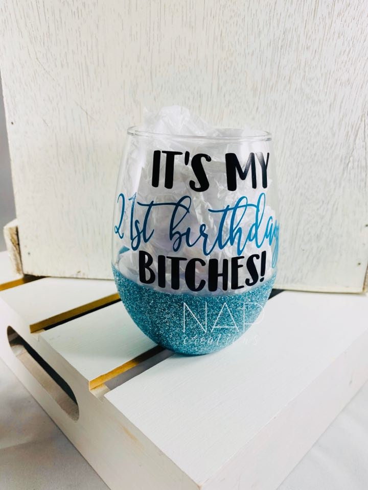 A stylish stemless wine glass with glitter and 'It's My 21st Birthday Bitches' design, perfect for birthday celebrations.