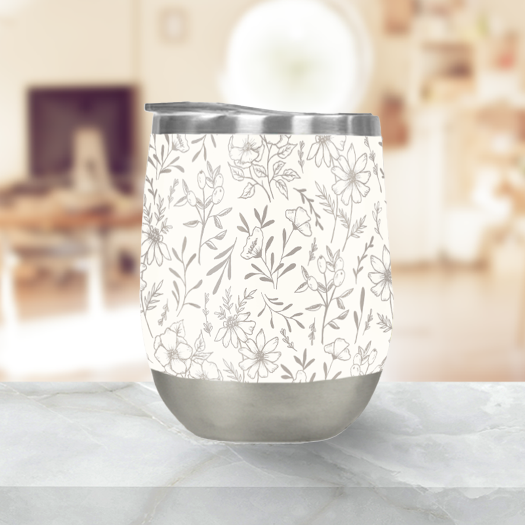 Ivory Flower Stemless Wine Tumbler showcasing its elegant design and stainless steel construction, perfect for outdoor use.
