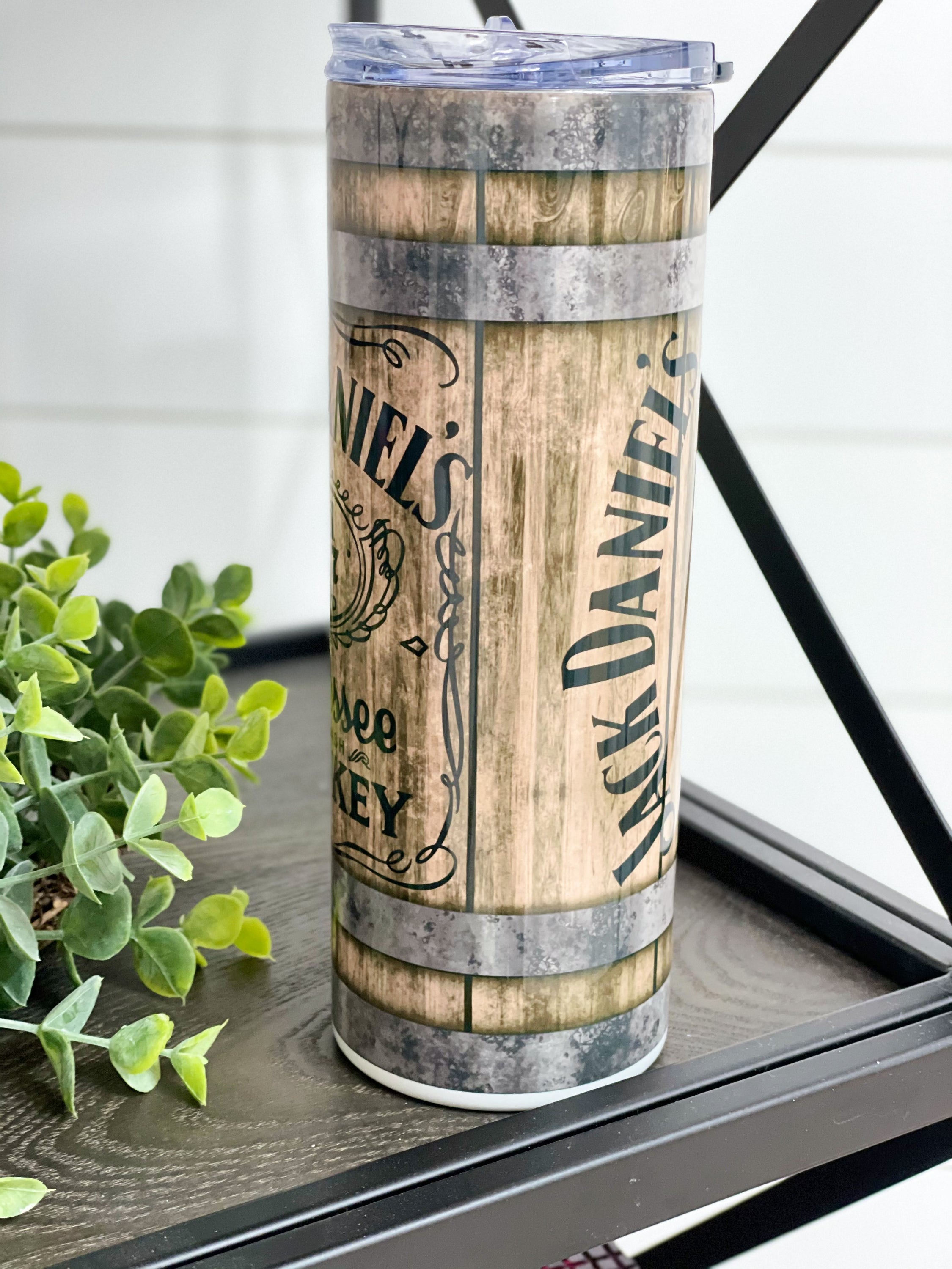 Jack Daniels 20oz Skinny Tumbler with full wrap design and reusable straw, perfect for hot and cold beverages.