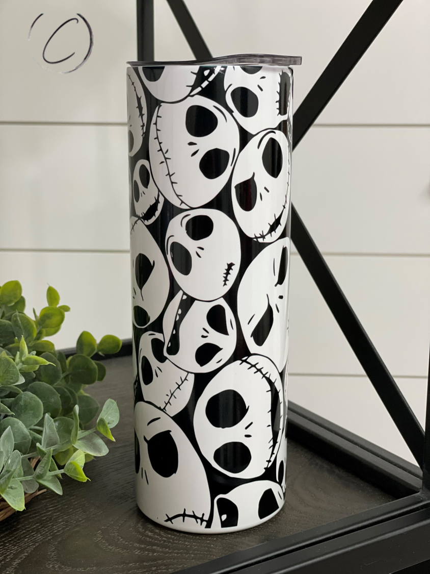 Jack Skellington 20oz UV Orange Skinny Tumbler with vibrant color-changing design in sunlight, featuring a reusable straw.