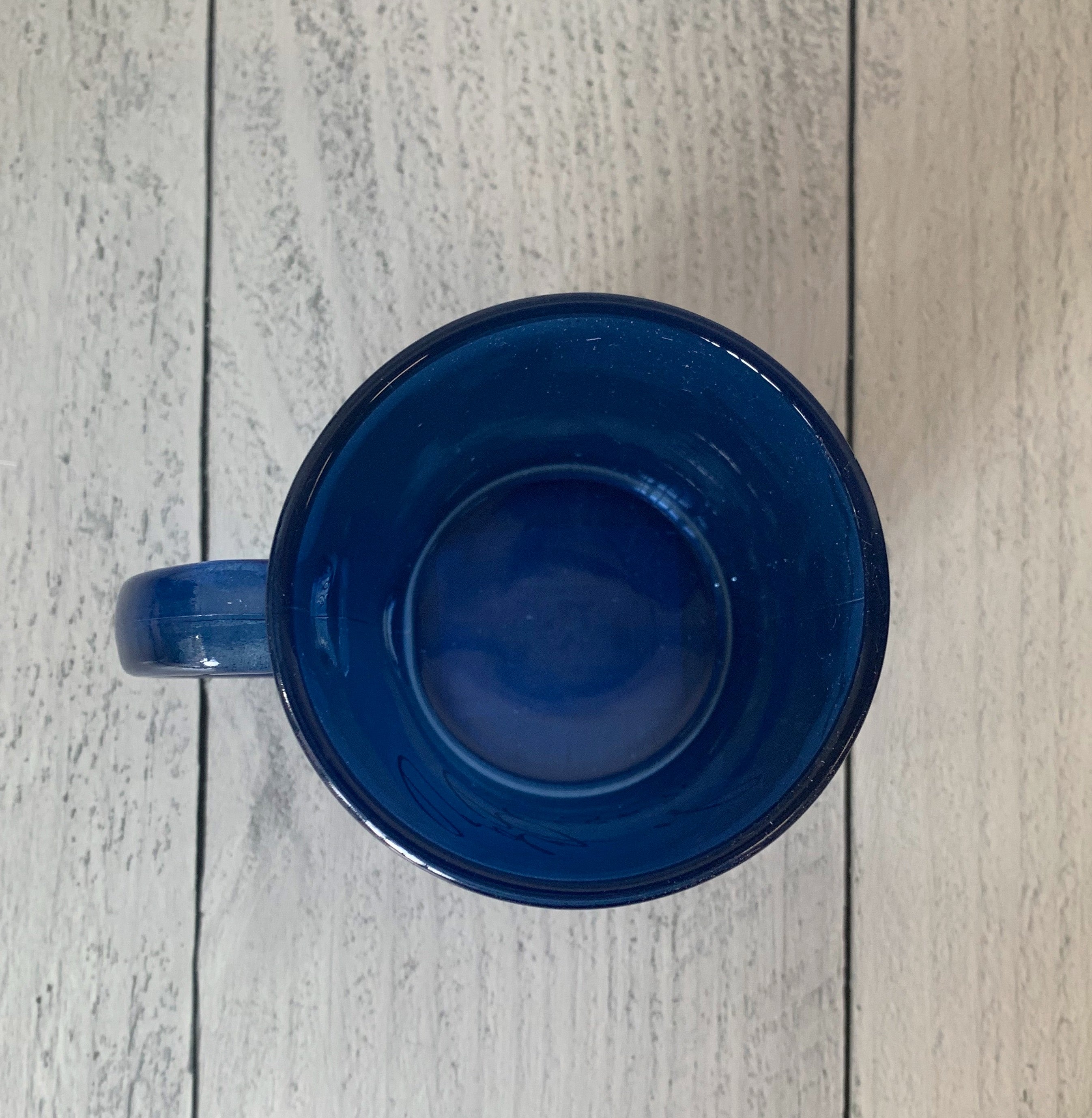 Lady of Leisure Single-Wall Glass Mug in dark blue tinted glass with gold lettering, elegantly designed for stylish sipping.