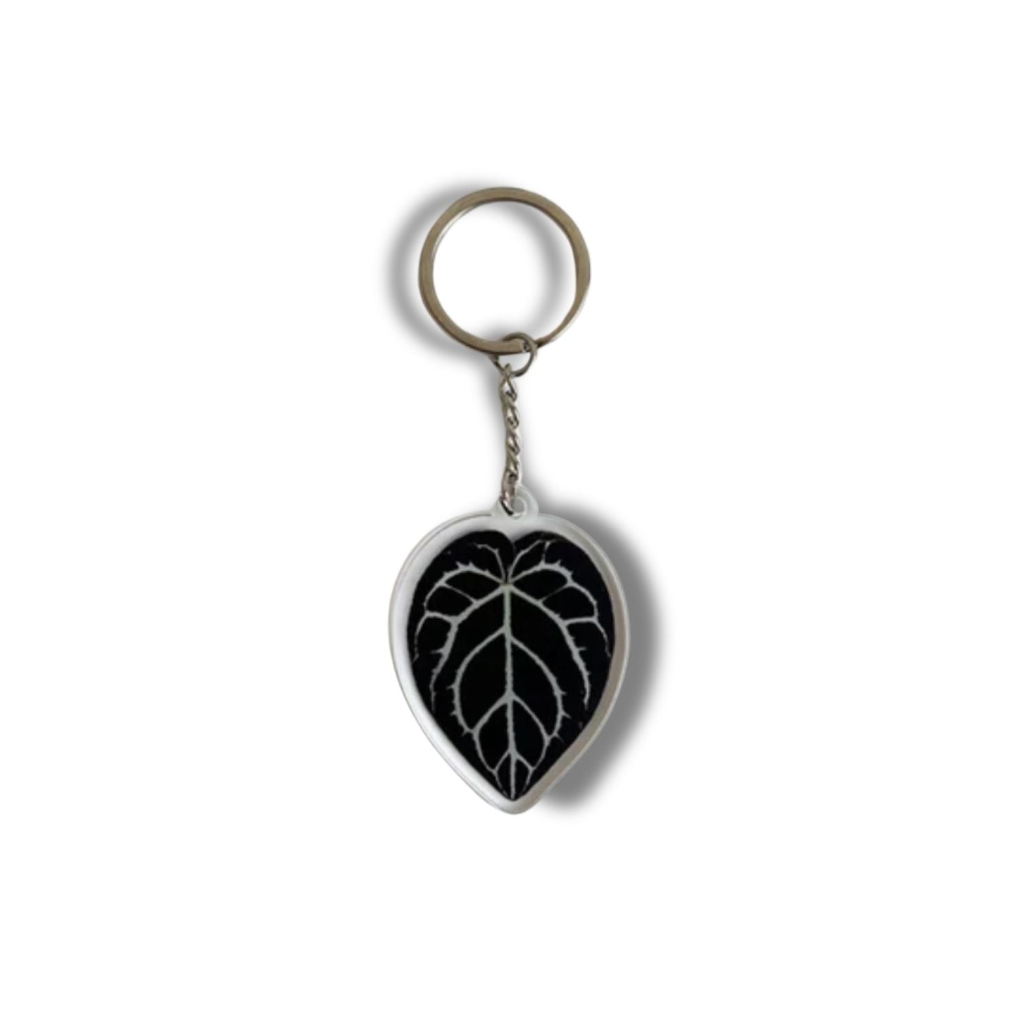 A collection of seven illustrated leaf acrylic keychains displayed on a clear background, showcasing vibrant colors and double-sided designs.