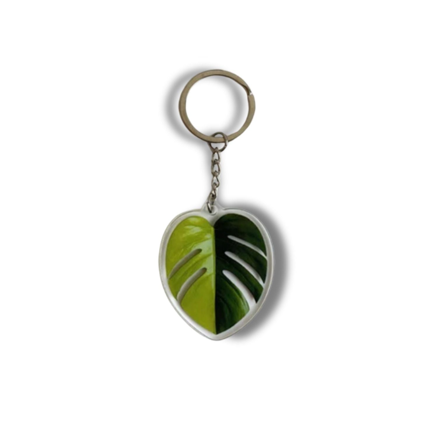 A collection of seven illustrated leaf acrylic keychains displayed on a clear background, showcasing vibrant colors and double-sided designs.