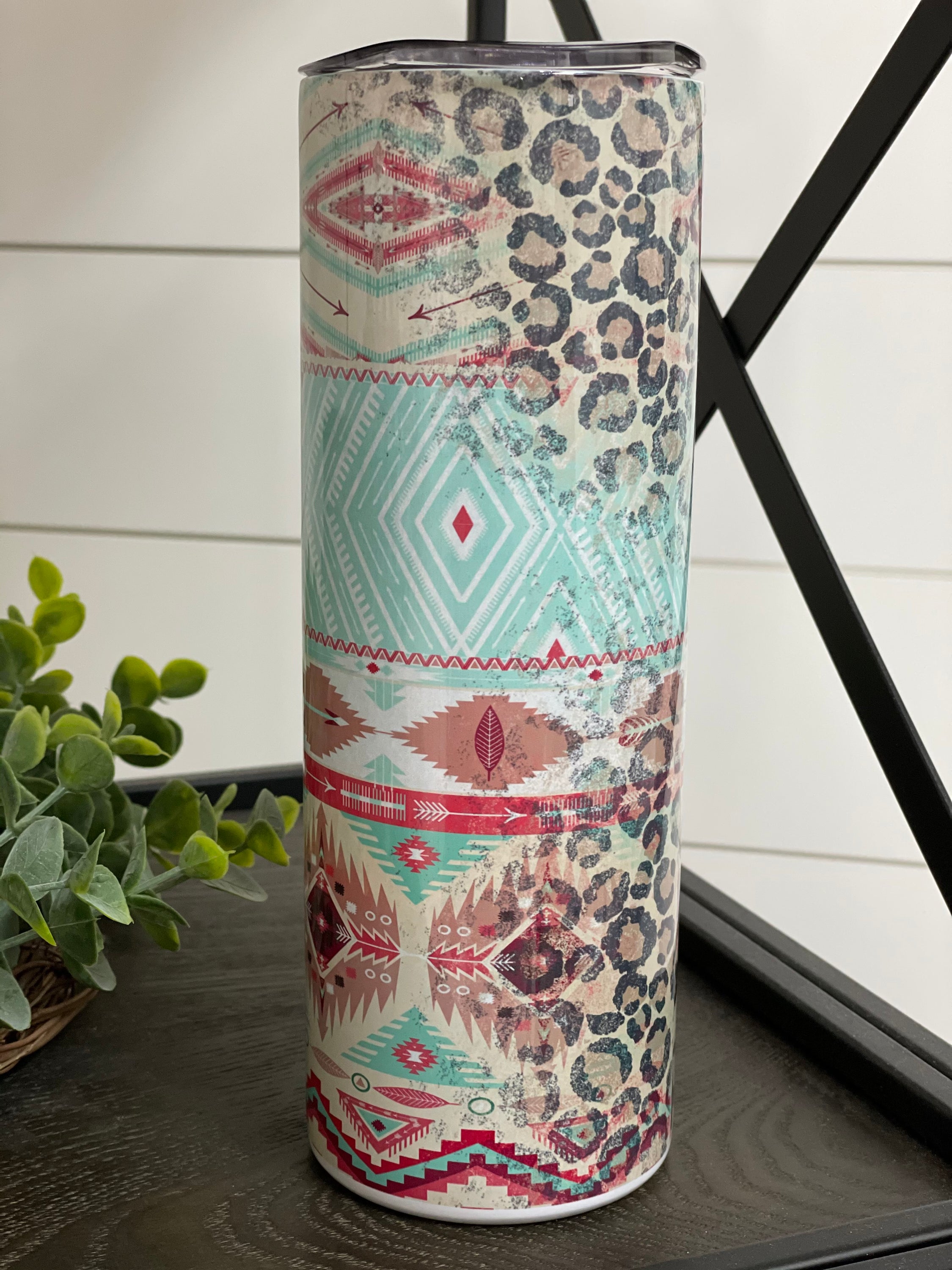 Leopard Aztec 20oz Skinny Tumbler with a vibrant full wrap design featuring leopard and Aztec patterns, complete with a reusable straw.