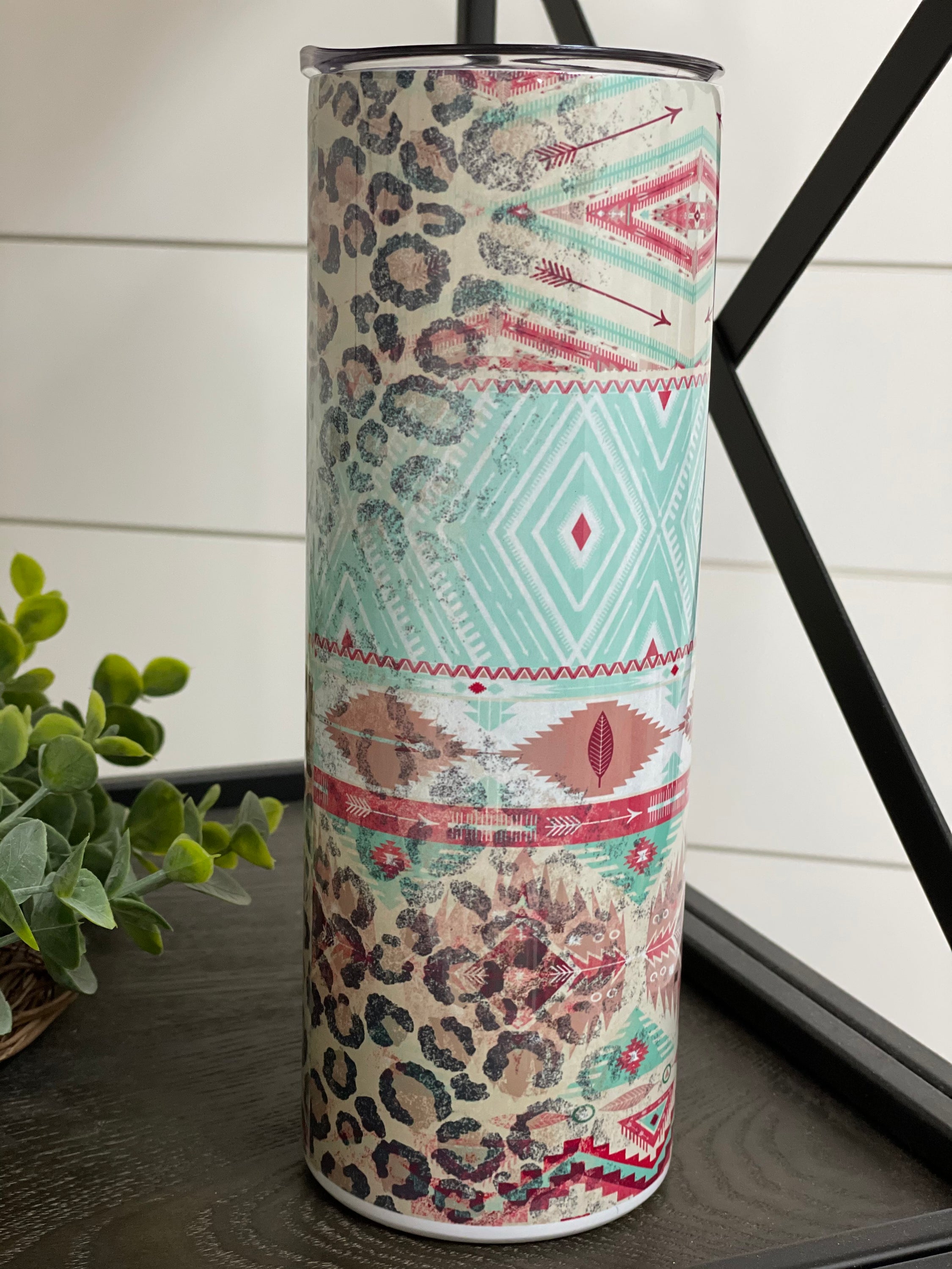 Leopard Aztec 20oz Skinny Tumbler with a vibrant full wrap design featuring leopard and Aztec patterns, complete with a reusable straw.