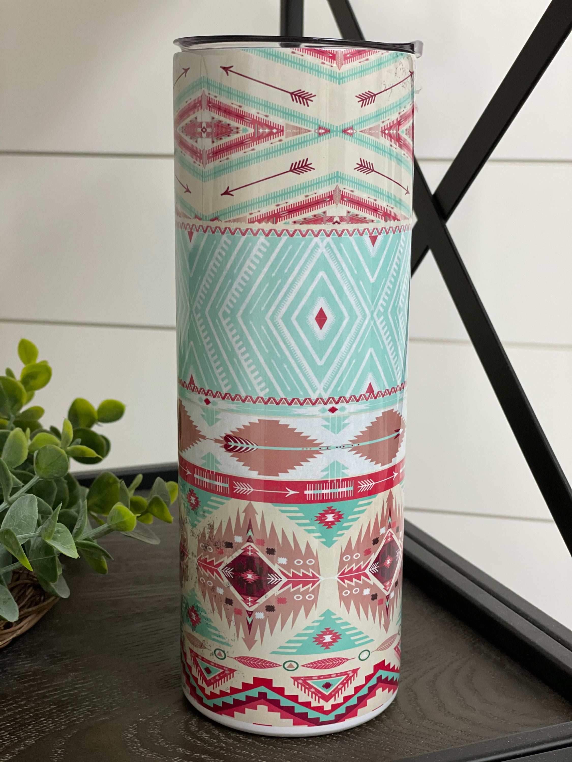Leopard Aztec 20oz Skinny Tumbler with a vibrant full wrap design featuring leopard and Aztec patterns, complete with a reusable straw.