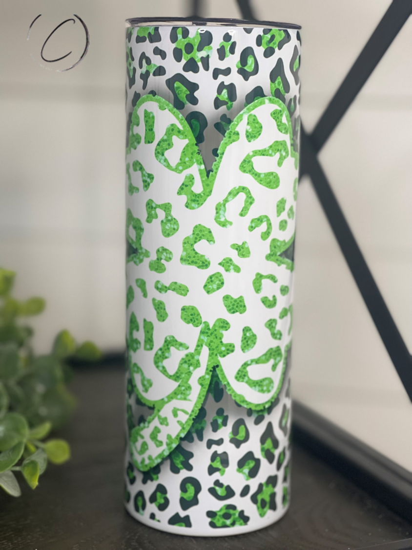 Leopard Shamrock 20oz Skinny Tumbler featuring a vibrant leopard and shamrock design, perfect for hot and cold beverages.