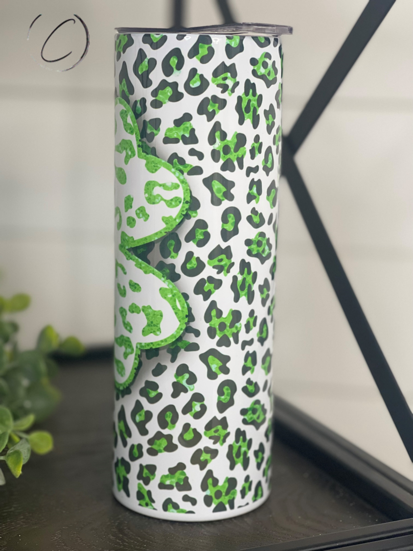 Leopard Shamrock 20oz Skinny Tumbler featuring a vibrant leopard and shamrock design, perfect for hot and cold beverages.