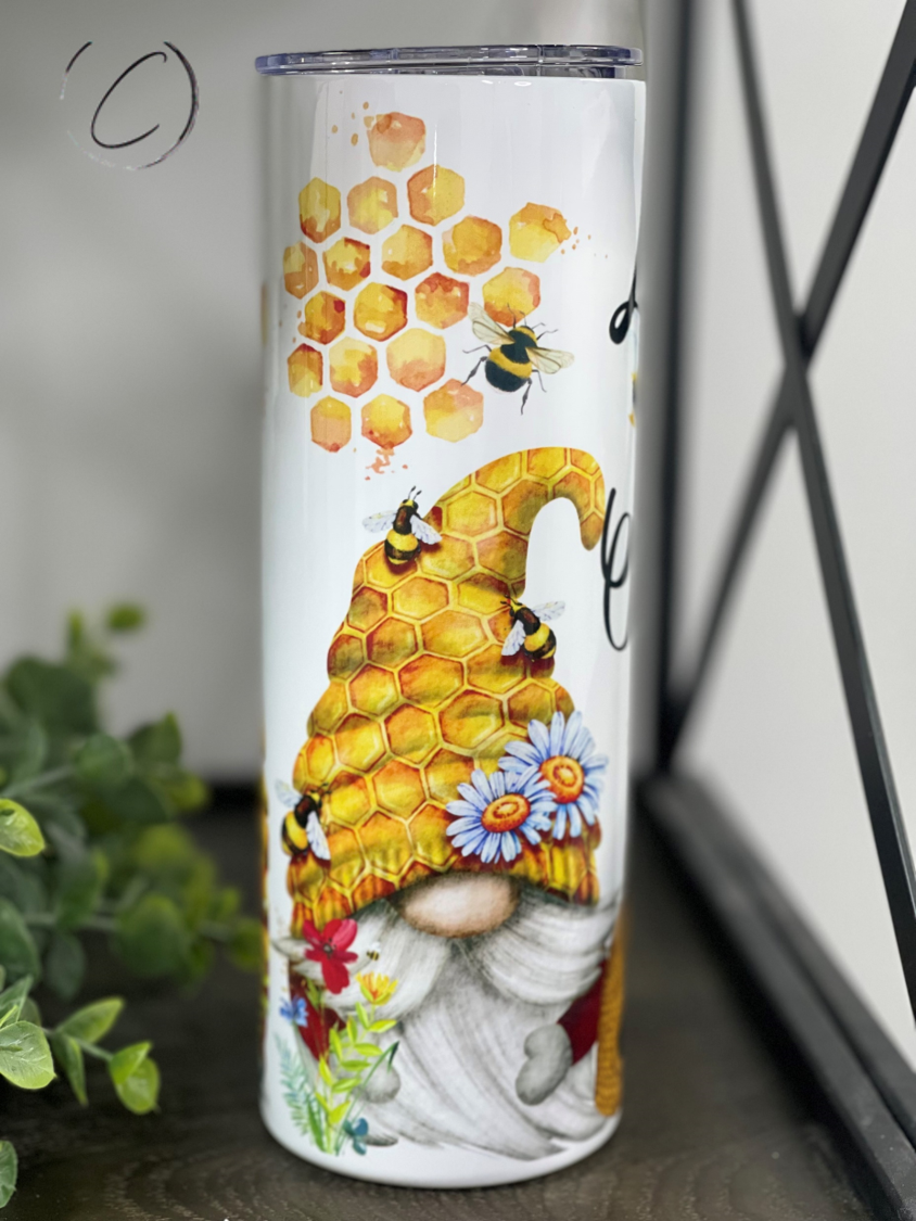 Let It Bee Gnomes 20oz Skinny Tumbler featuring a whimsical gnome design, perfect for hot and cold beverages.