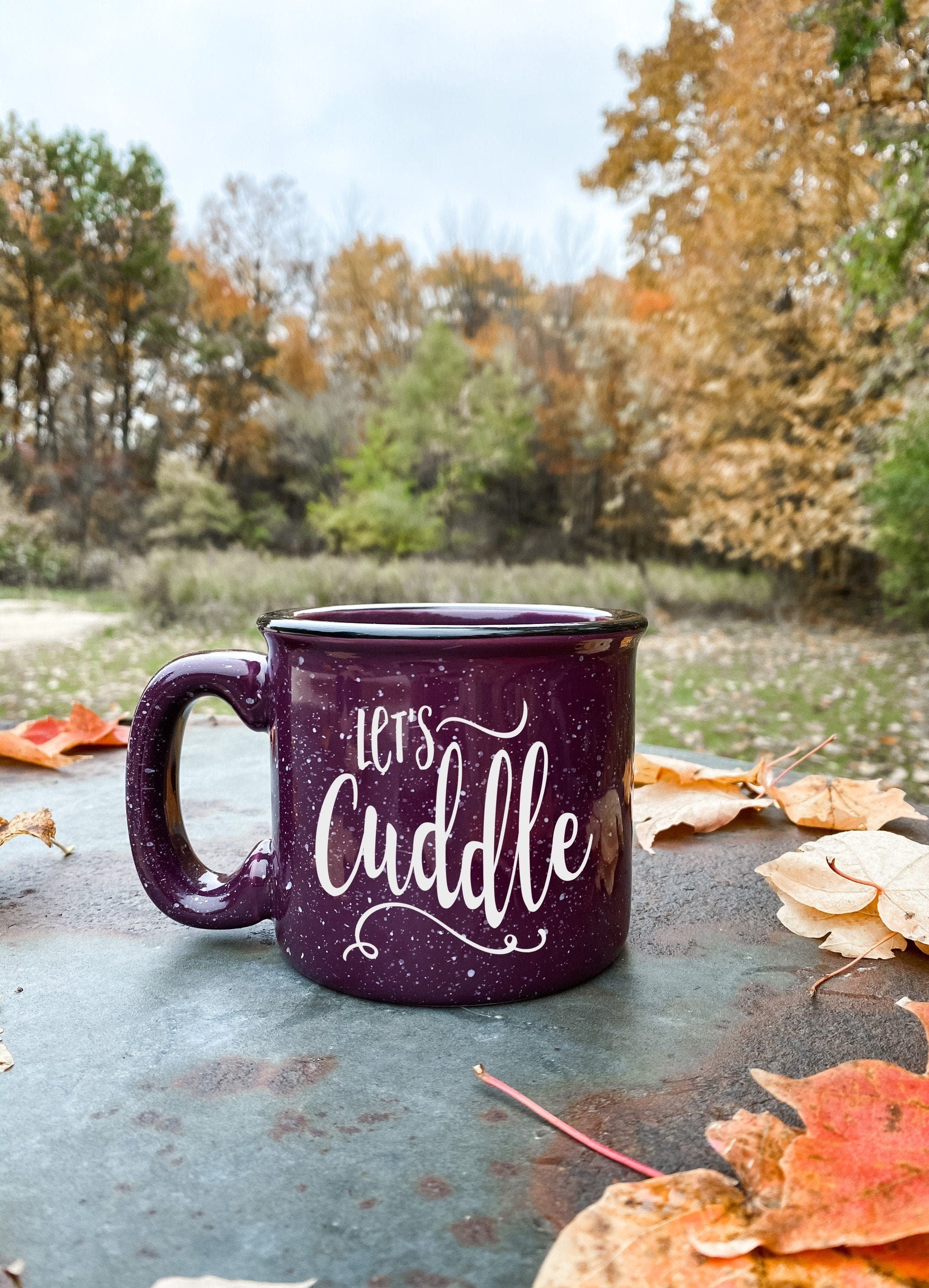 Let's Cuddle Campfire Mug, a 15 oz ceramic mug with a cozy design, perfect for warm beverages by the fire.