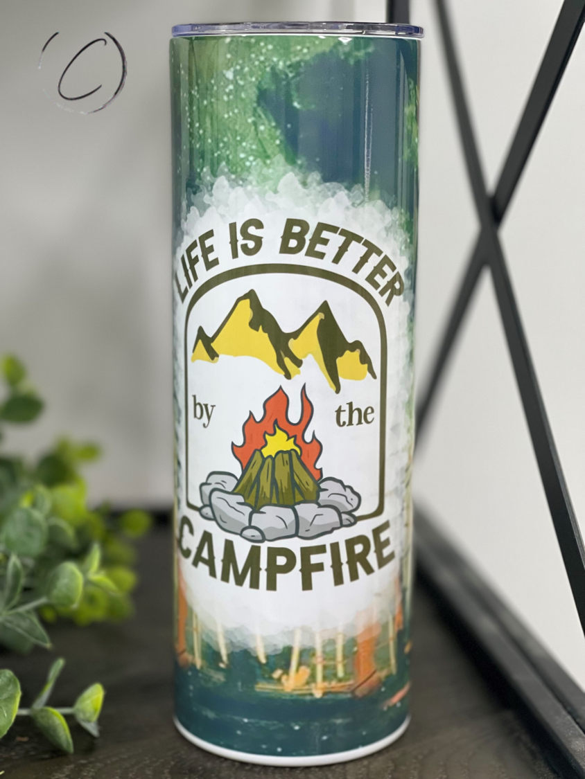 Life Is Better By The Campfire 20oz Skinny Tumbler with a vibrant outdoor-themed design, perfect for camping and outdoor activities.