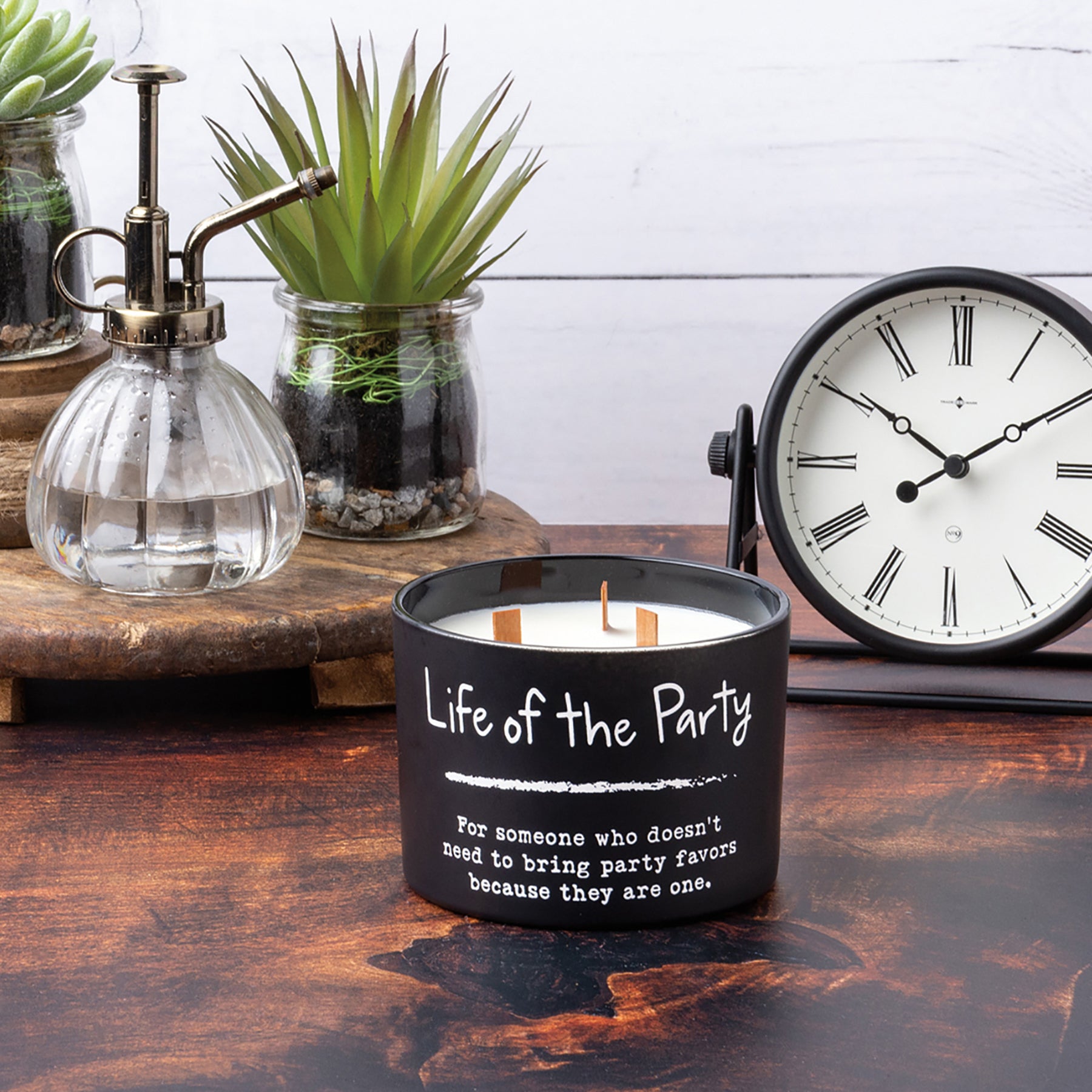 Life Of The Party jar candle in matte black glass with sea salt and sage scent, featuring three wooden wicks.
