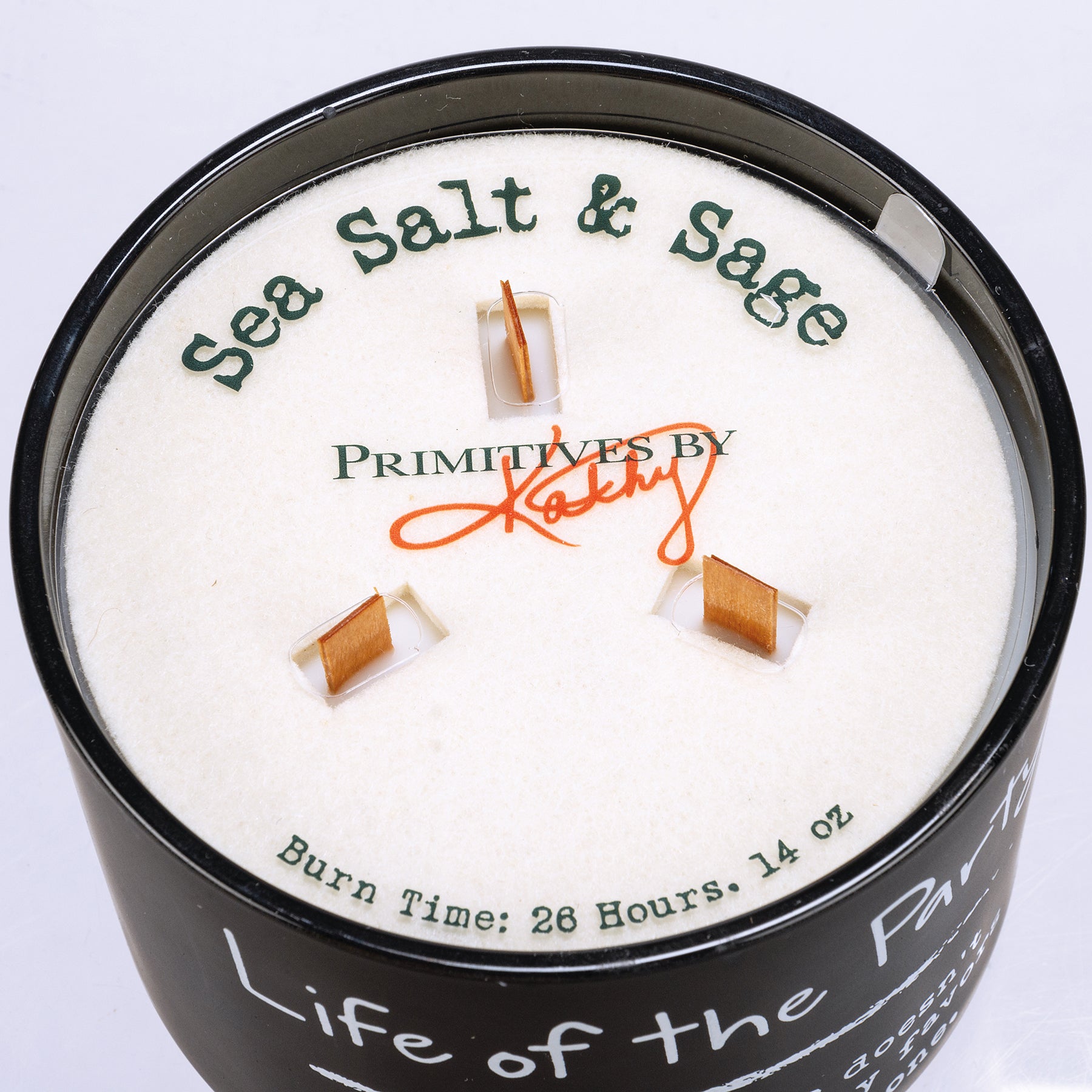 Life Of The Party jar candle in matte black glass with sea salt and sage scent, featuring three wooden wicks.