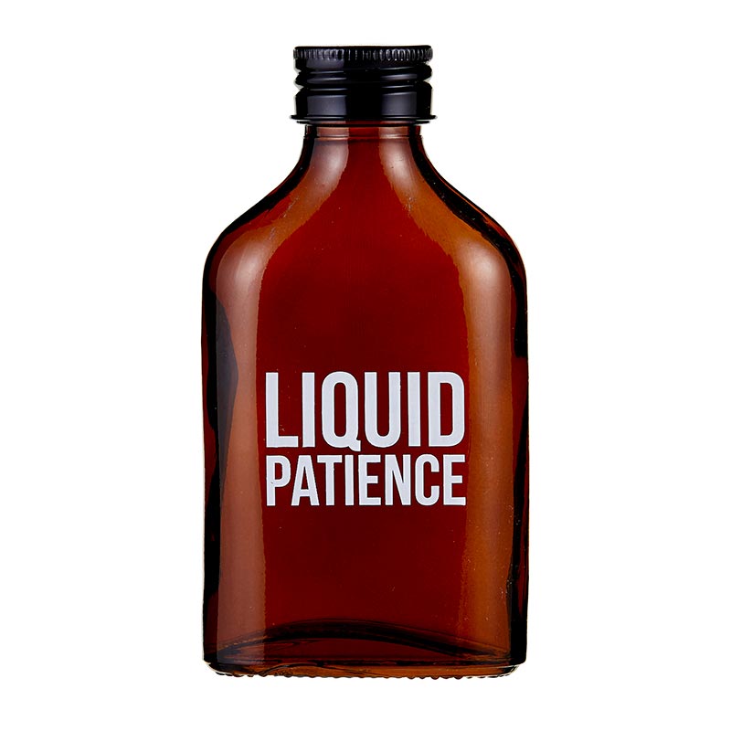 Liquid Patience Amber Mini Flask made of glass and metal, featuring humorous prints and an elegant amber color.