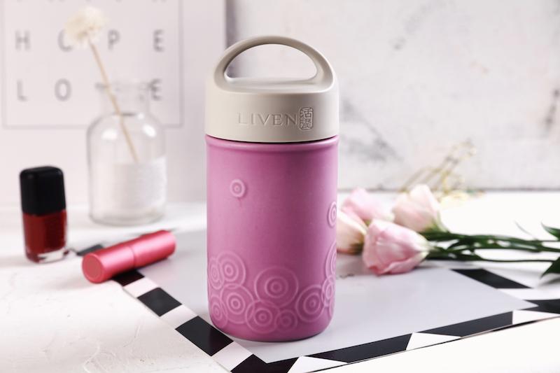 Liven Destiny Travel Mug featuring a tourmaline ceramic body, silicone cover, and convenient carrying handle, perfect for on-the-go hydration.