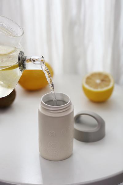 Liven Destiny Travel Mug featuring a tourmaline ceramic body, silicone cover, and convenient carrying handle, perfect for on-the-go hydration.